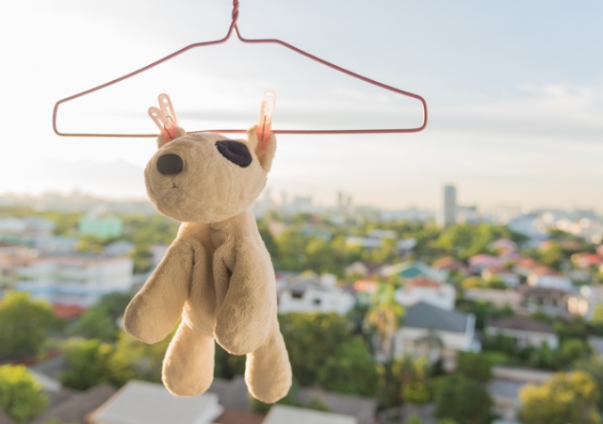 Children's soft toys soaking in cleaning solution with vinegar and detergent to remove mould