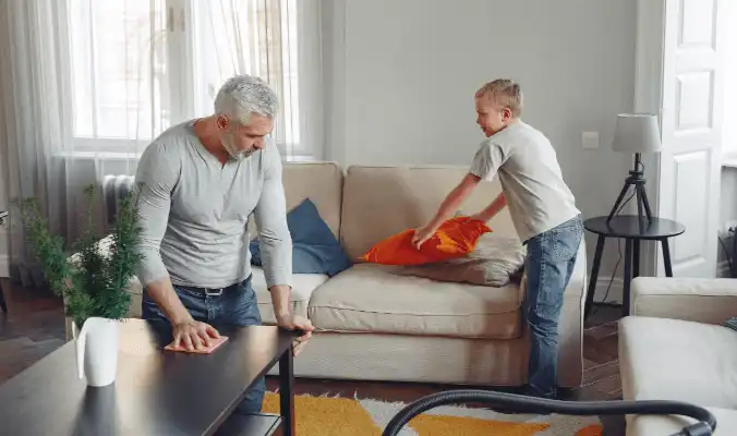 father and son disinfecting the lounge