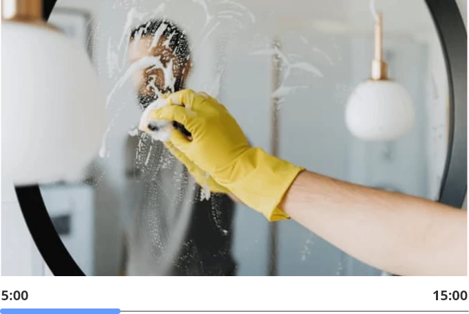 man cleaning the bathroom mirrors