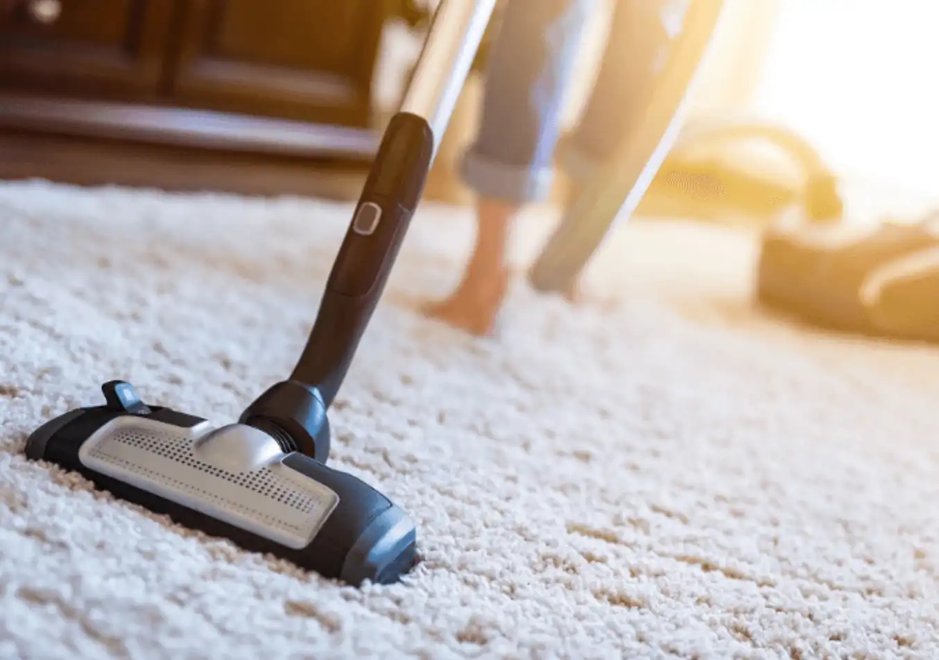 using a vacuum to clean the carpet