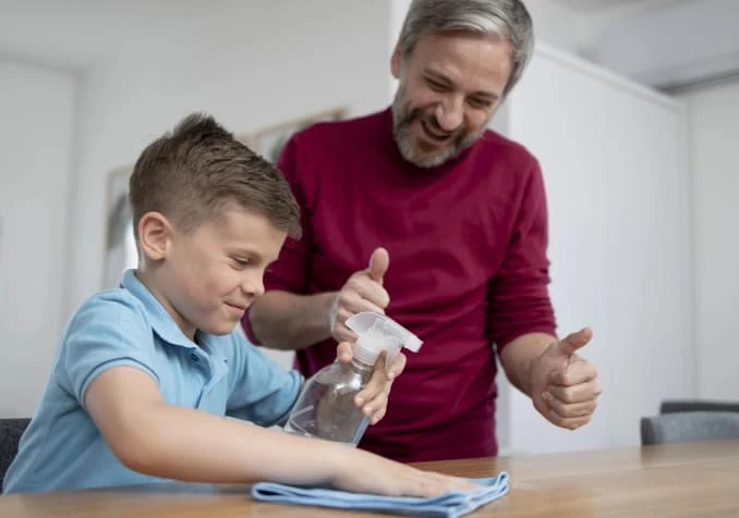 father teaching child chores