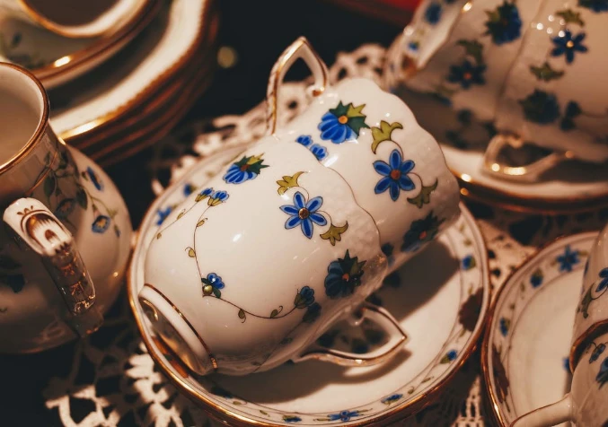 properly piled up porcelain teacups and saucers