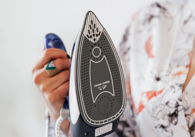 Heat treatment using a moist towel and iron on a carpet stain.