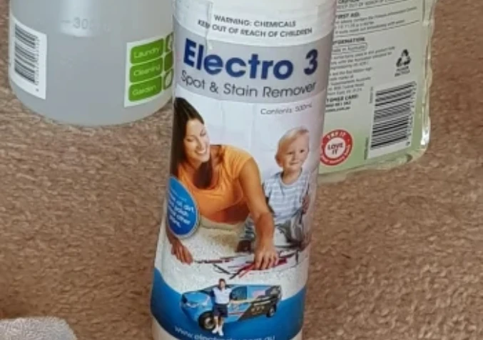 applying Electro 3 spot and stain remover to treat coke stain on carpet
